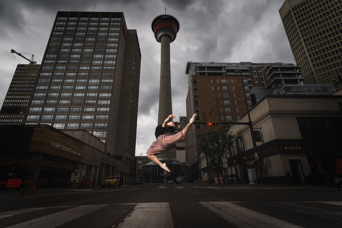 Clara Kearl jumping in front of Calgary tower